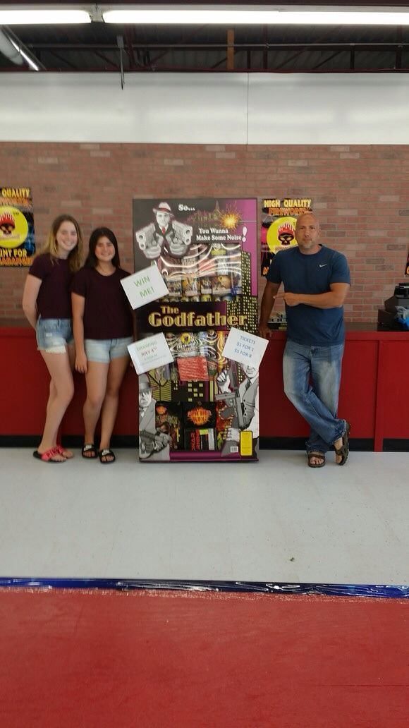 A group of people standing in front of a sign that says godfather.