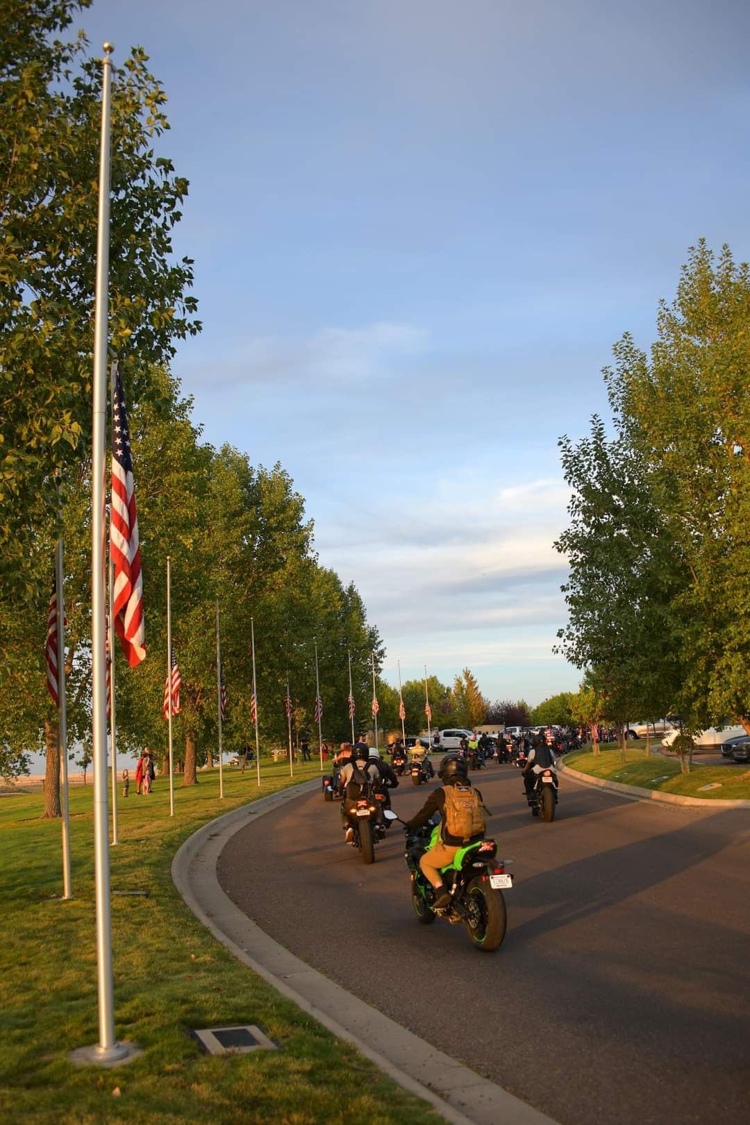 A group of people are riding motorcycles down a street.