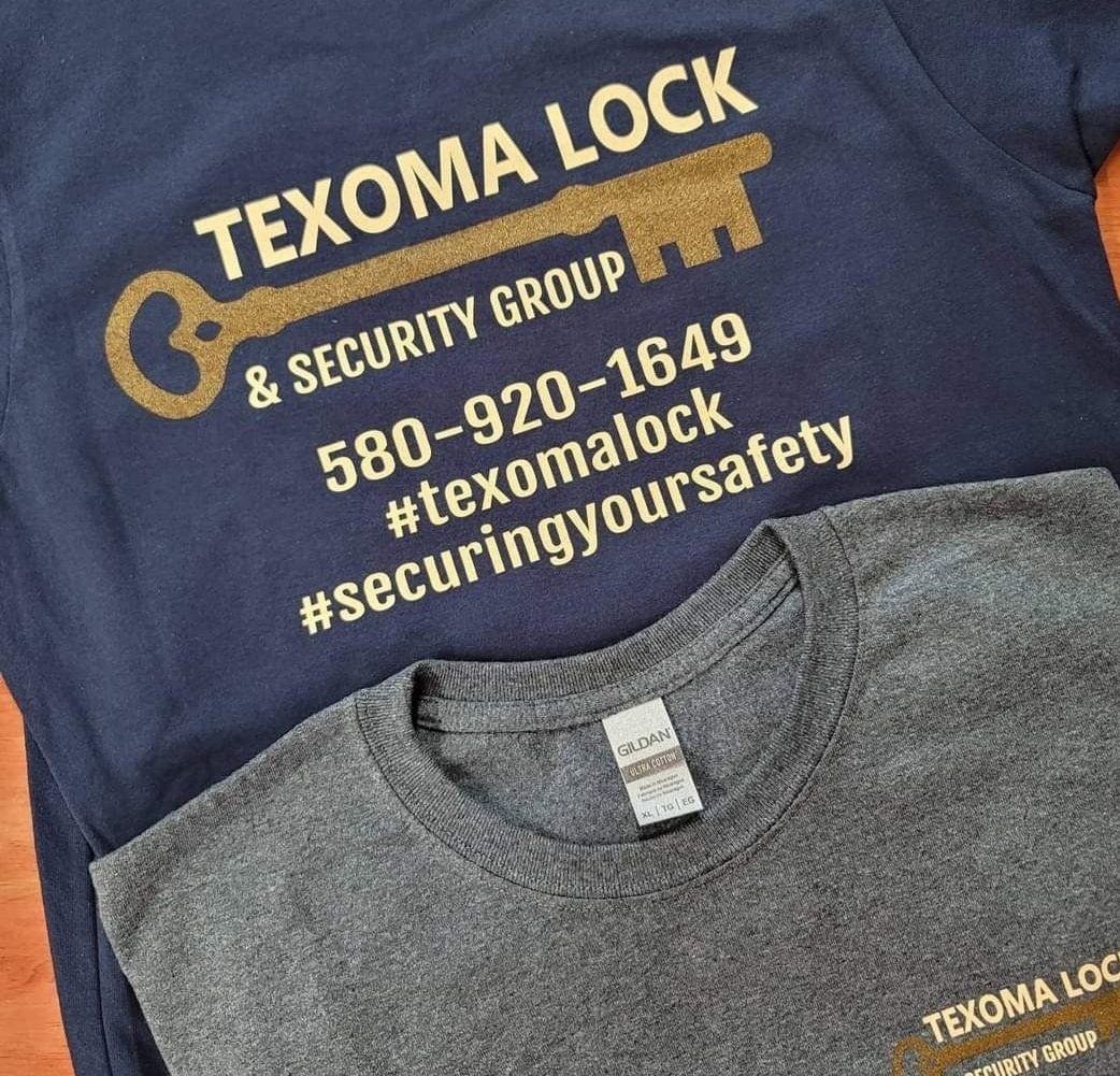 Two Texoma Lock & Security Group t-shirts; one dark blue, one gray. The dark blue shirt displays contact information and a key graphic.