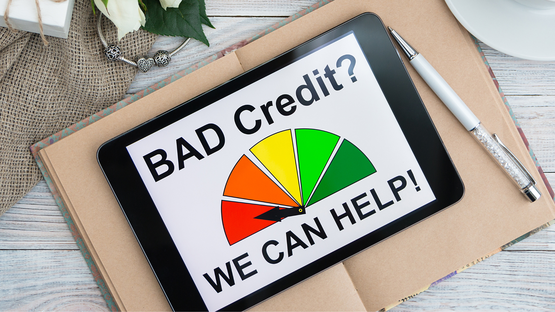 A tablet with the words `` bad credit ? we can help ! '' on it.