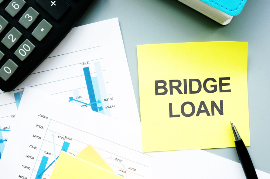 A yellow sticky note with the words bridge loan written on it