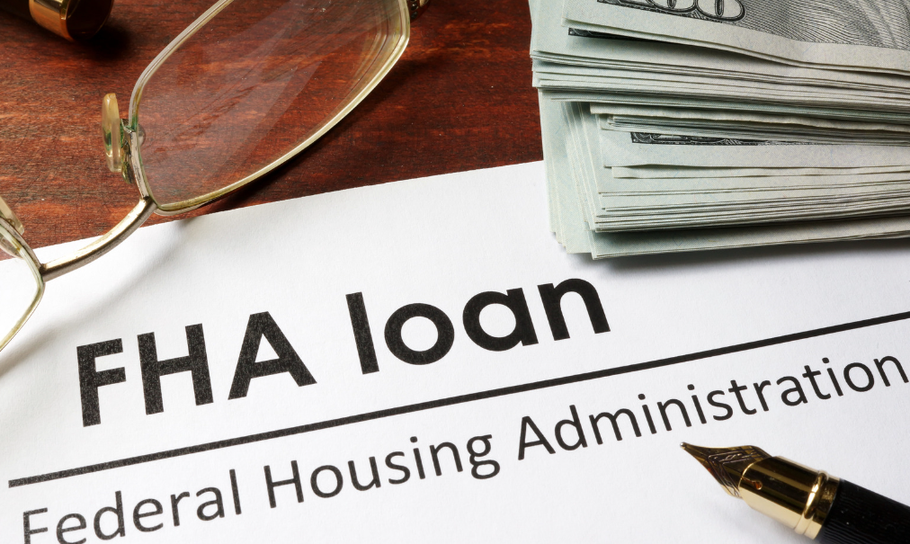 A fountain pen sits on top of a federal housing administration loan form