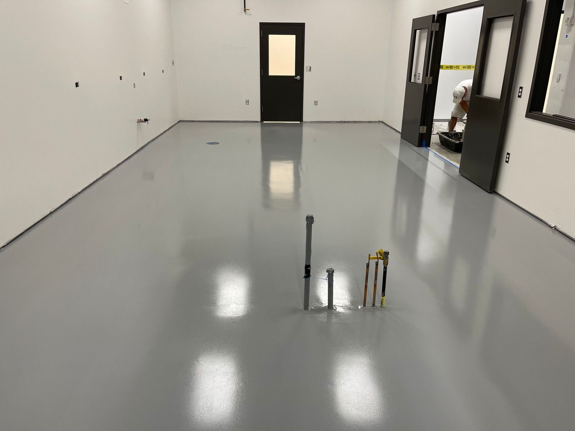 A large room with a gray floor and white walls.
