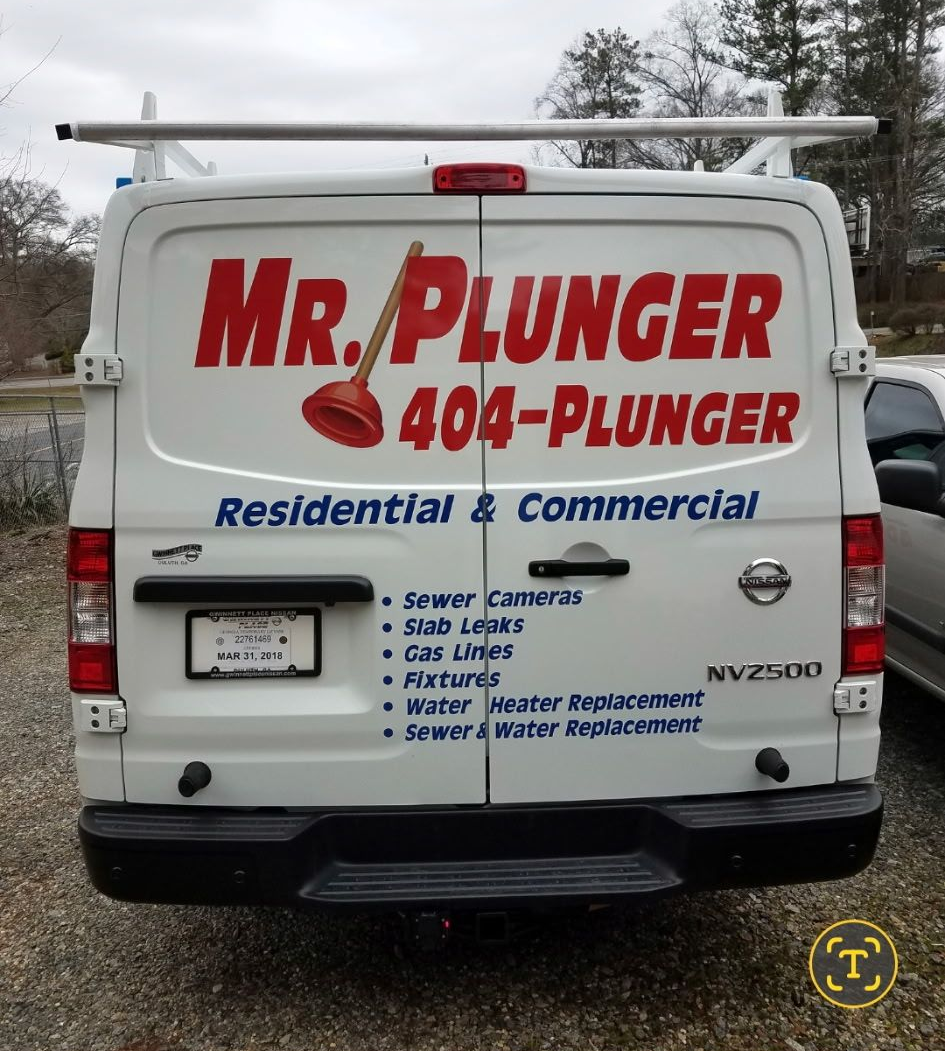 Plumber installing a water heater, wearing a tool belt and cap. Plumber installing a water heater, wearing a tool belt and cap.