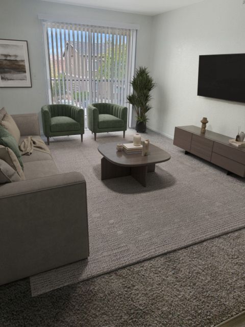 A modern living room with a grey sofa, two green armchairs, a coffee table, media console, and wall-mounted television.