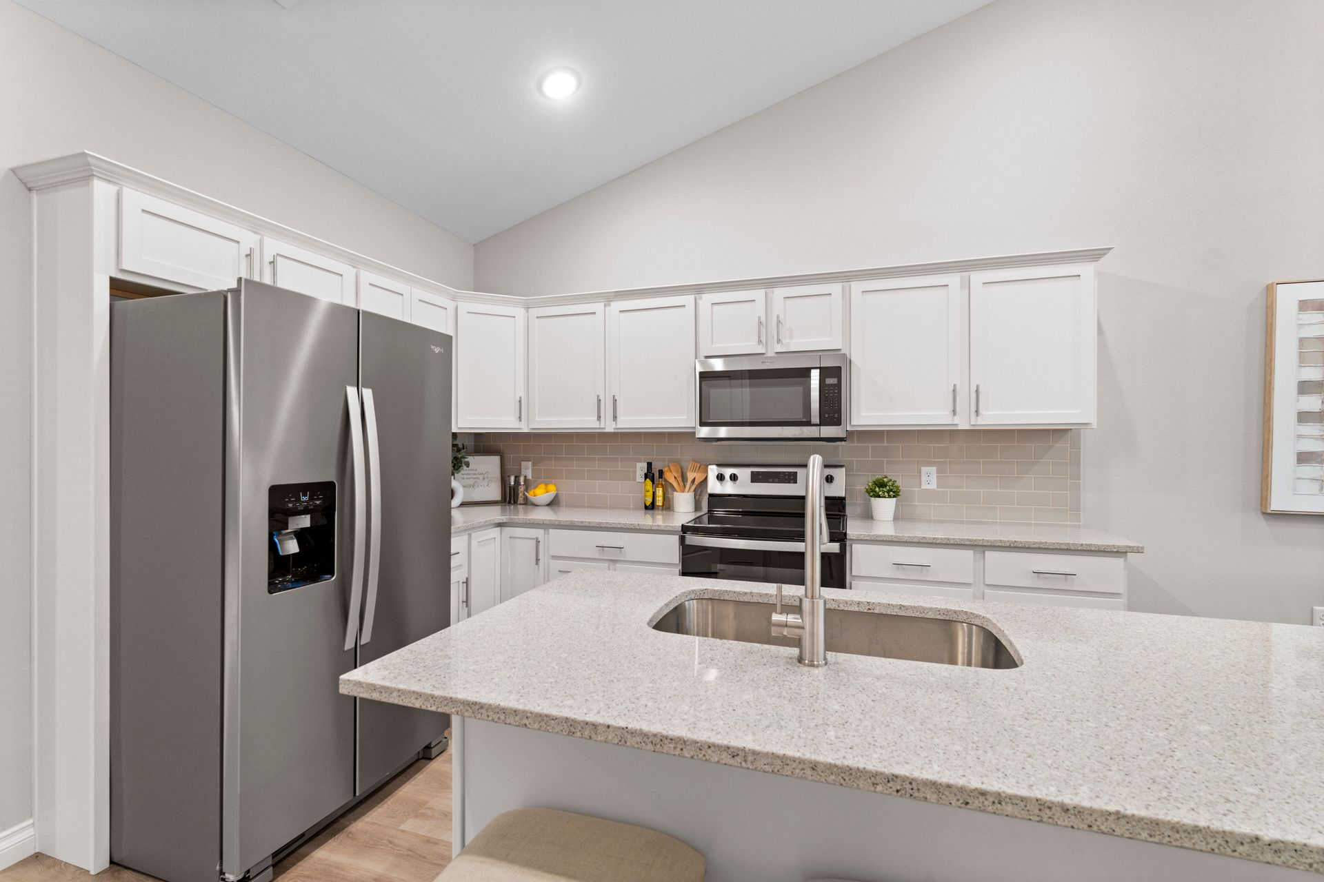 Photo of a kitchen with cabinets, an island and more