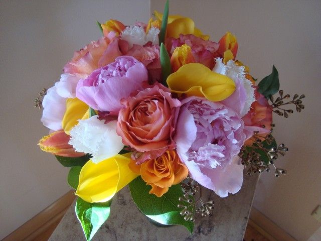 A bouquet of pink and yellow flowers in a vase