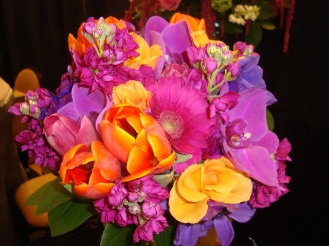 A bunch of colorful flowers are sitting on a table
