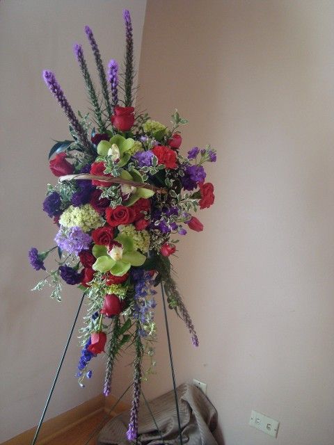 A display of flowers on a stand in a room
