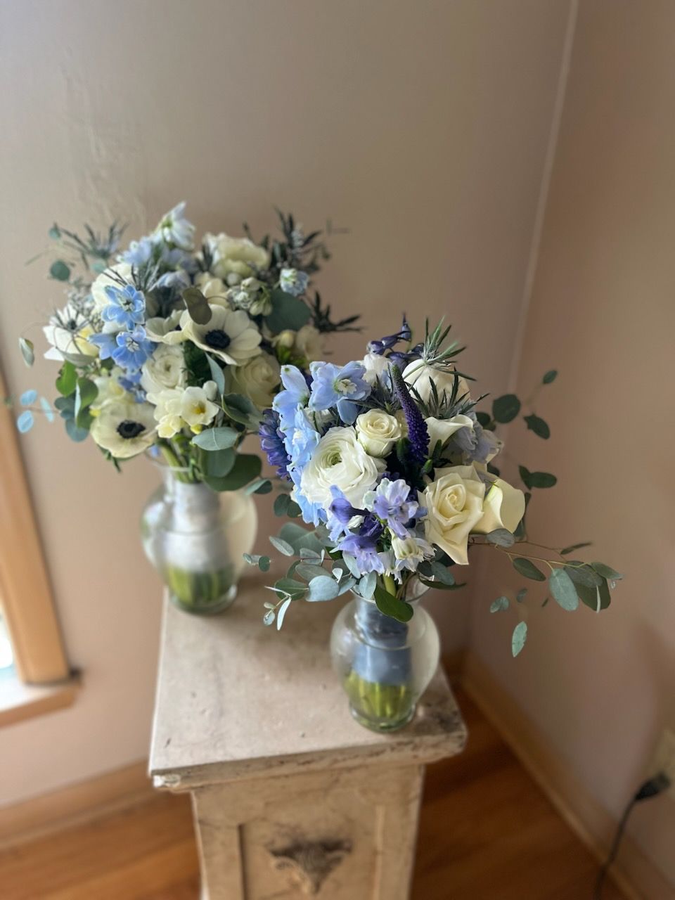 A vase filled with purple and blue flowers on a black background.