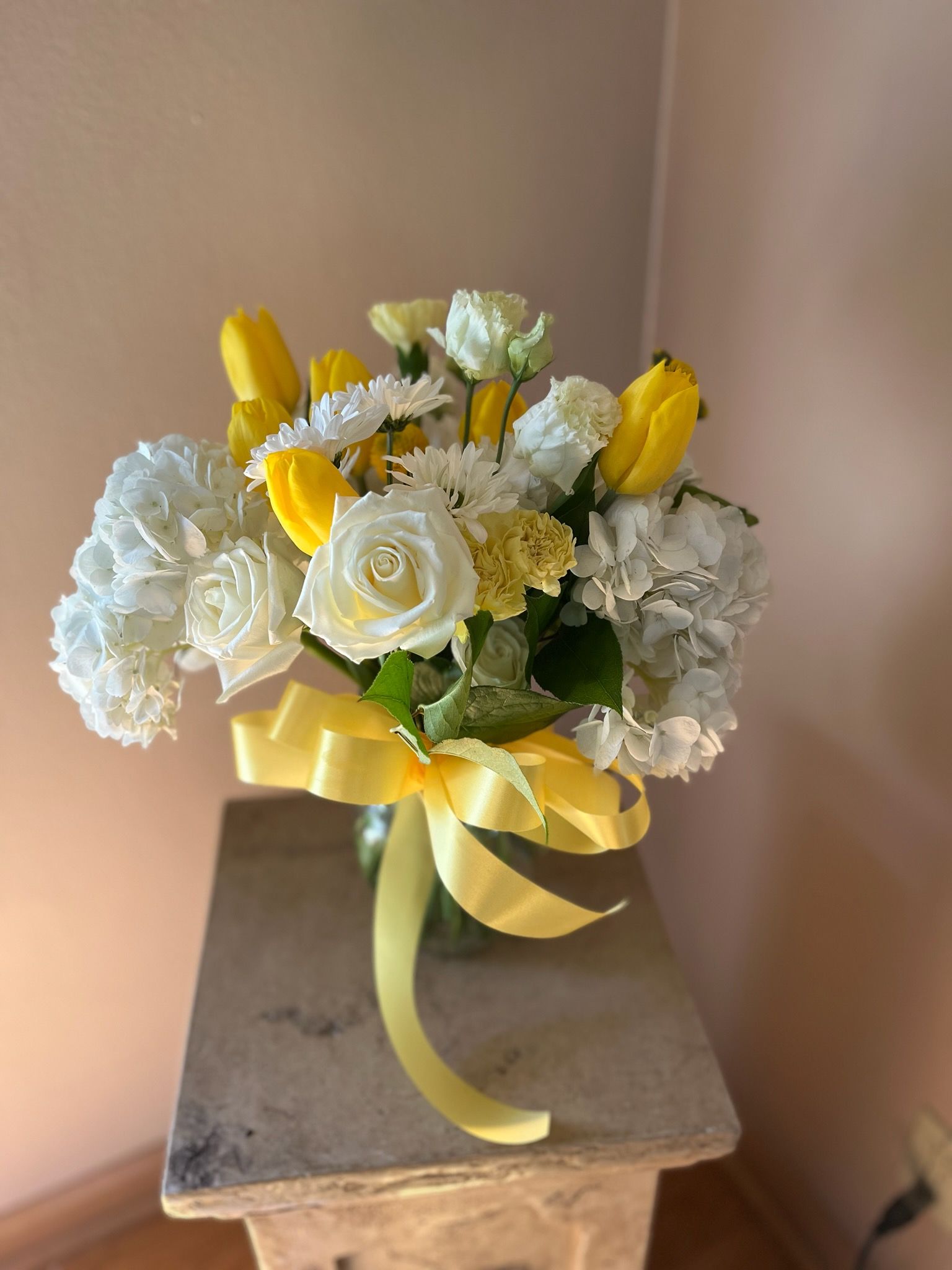 A vase filled with flowers is sitting on a table.