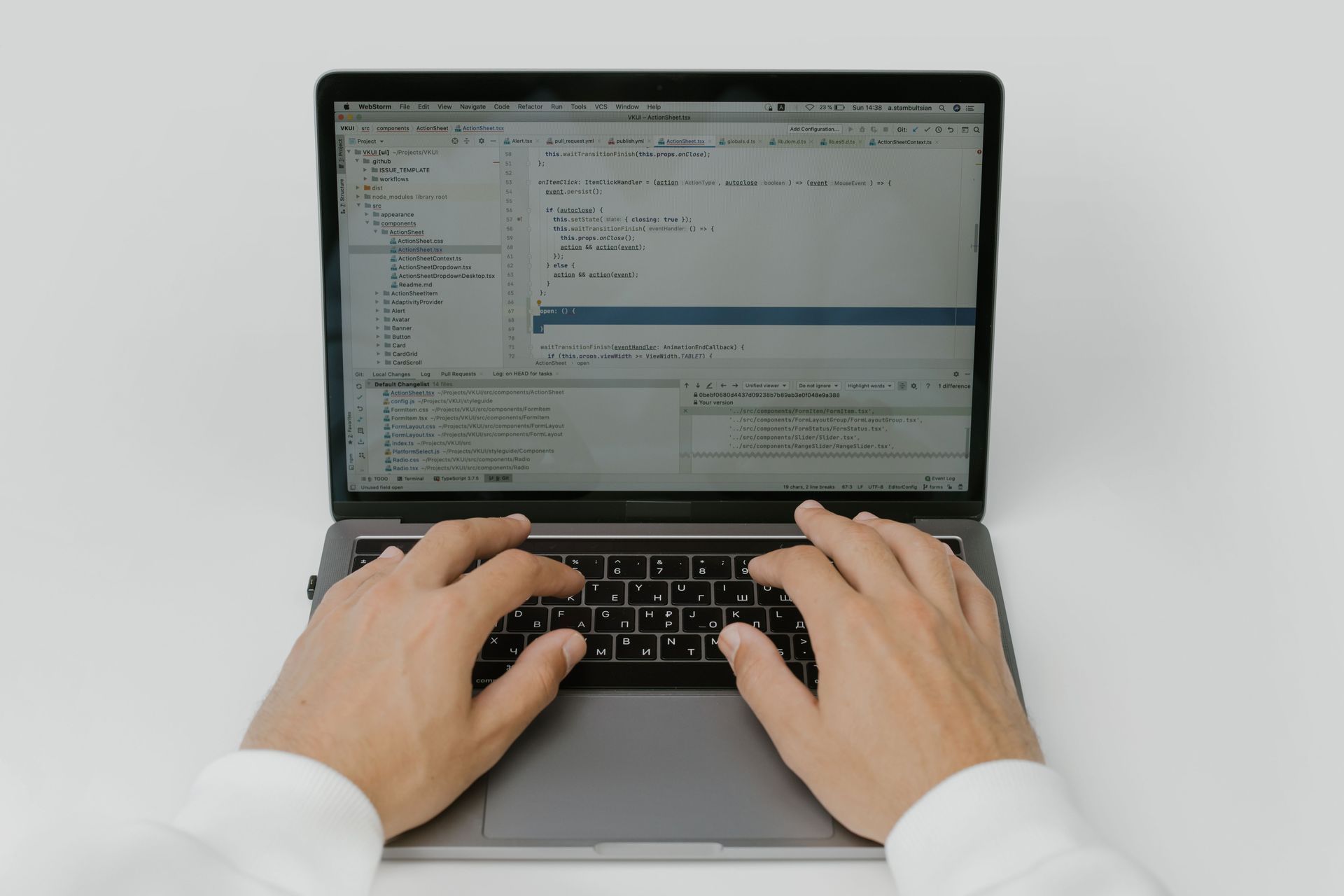 Business meeting with hands discussing documents, calculator, and laptop on a desk