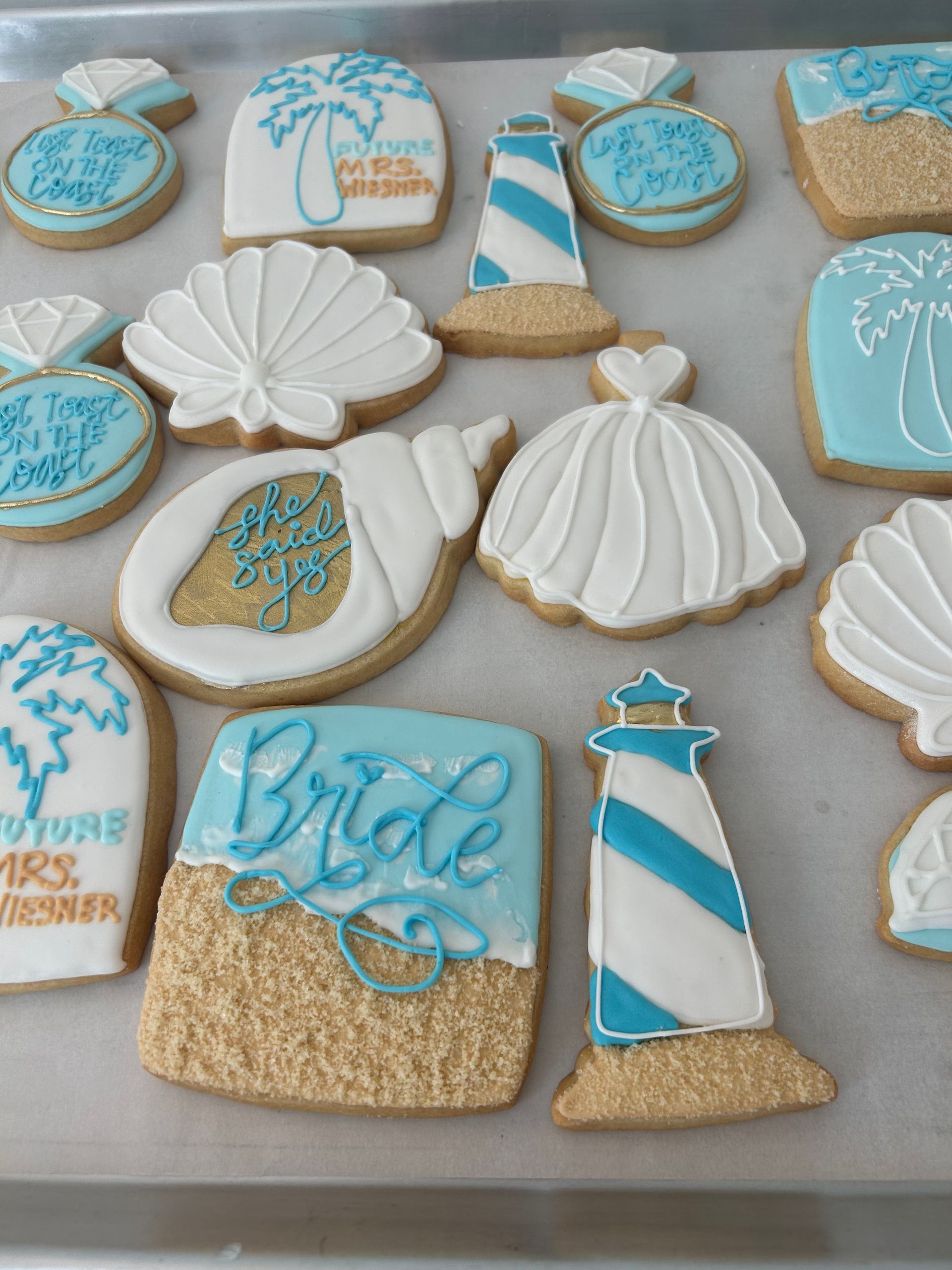 Three purple skeleton cookies are sitting on a white lace napkin