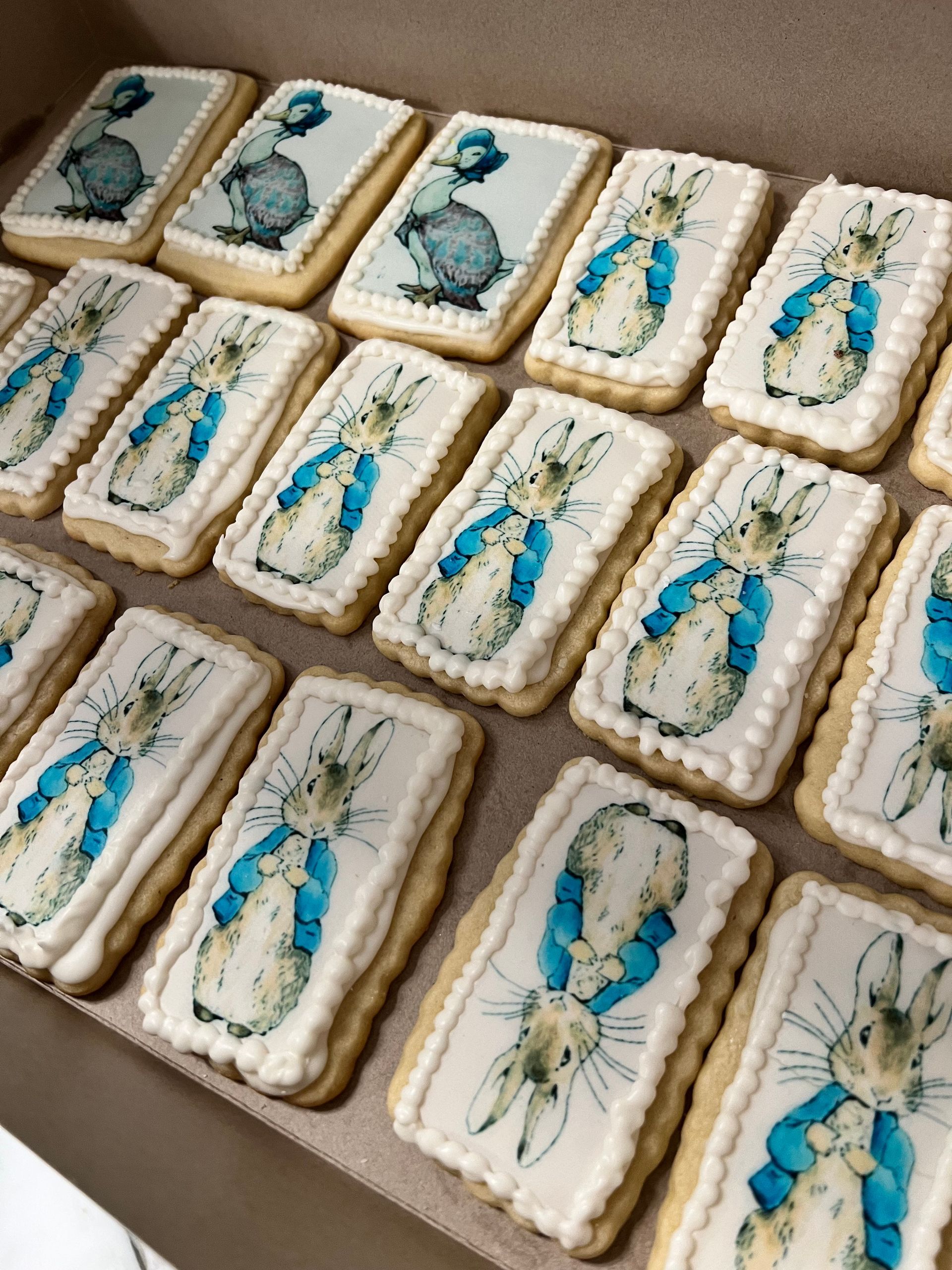 Three purple skeleton cookies are sitting on a white lace napkin