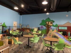 A large room with tables and chairs in it.