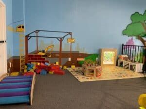 A room with a lot of toys on the floor.