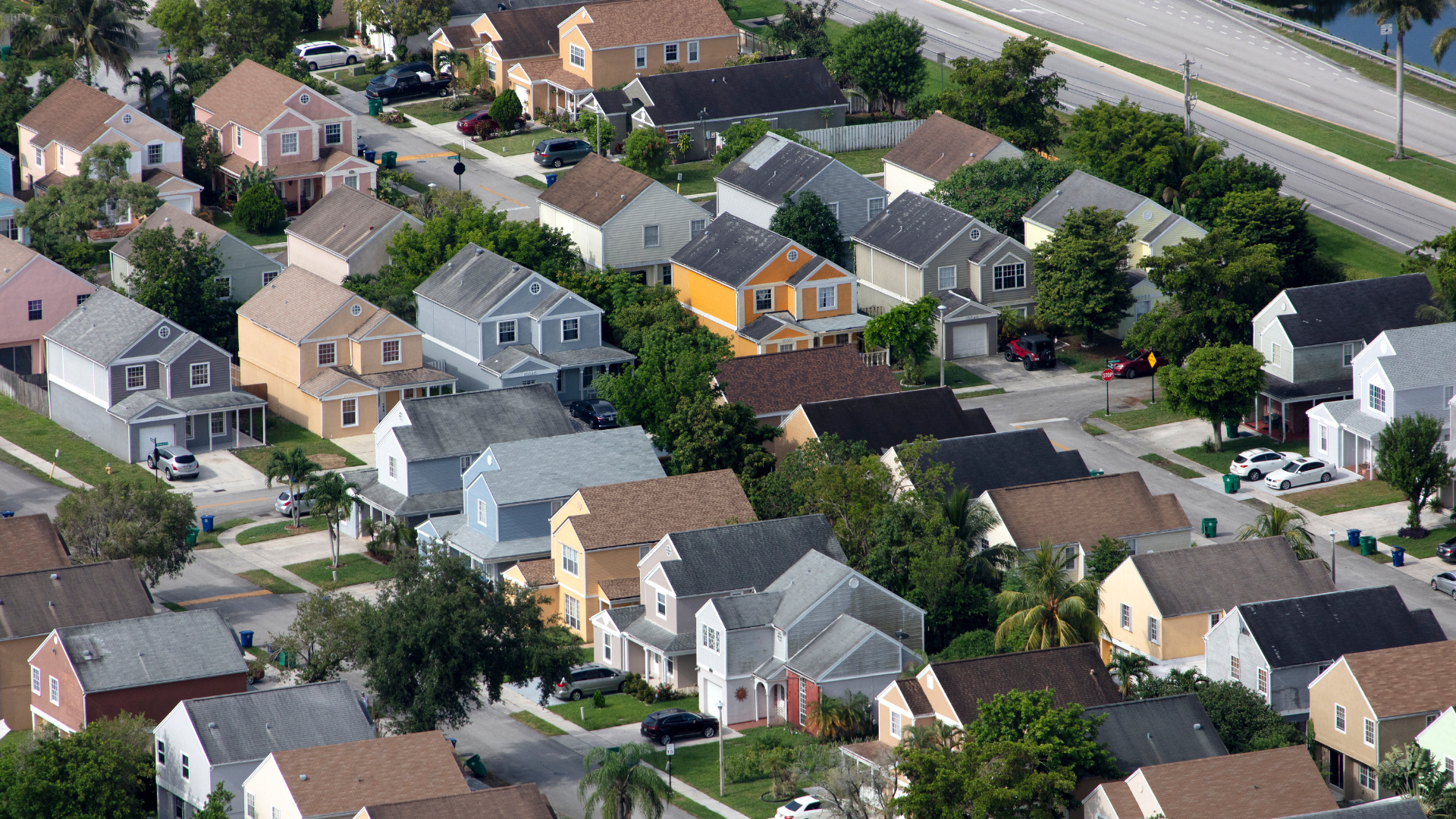 An aerial view of a residential neighborhood with lots of houses and trees