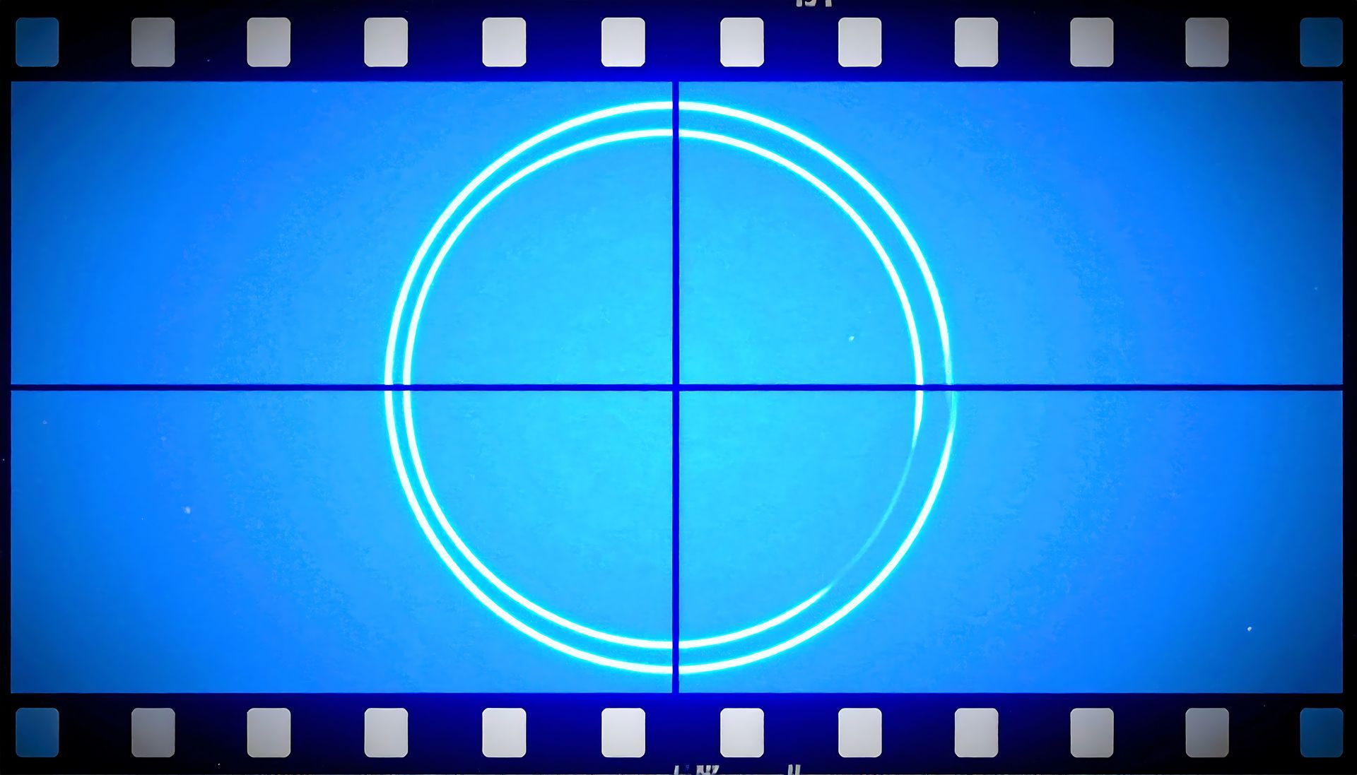 Blue film countdown screen with a glowing circle and horizontal line, framed by sprocket holes