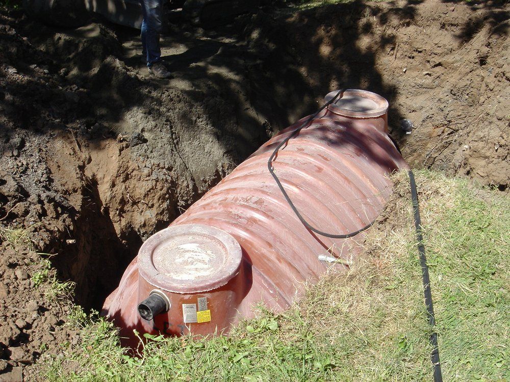 a septic tank is sitting in the middle of a hole in the ground .
