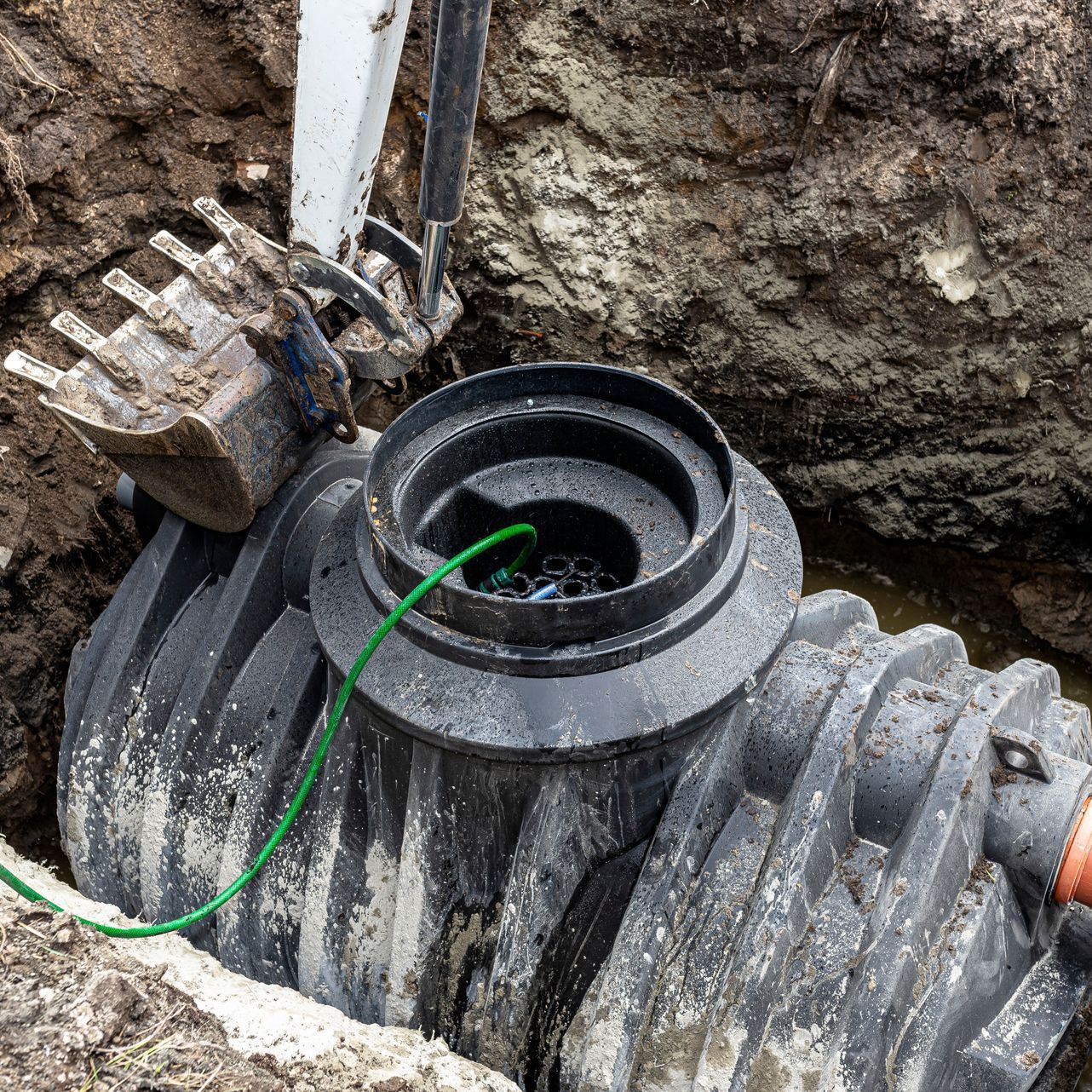 a septic tank is being installed in a hole in the ground .