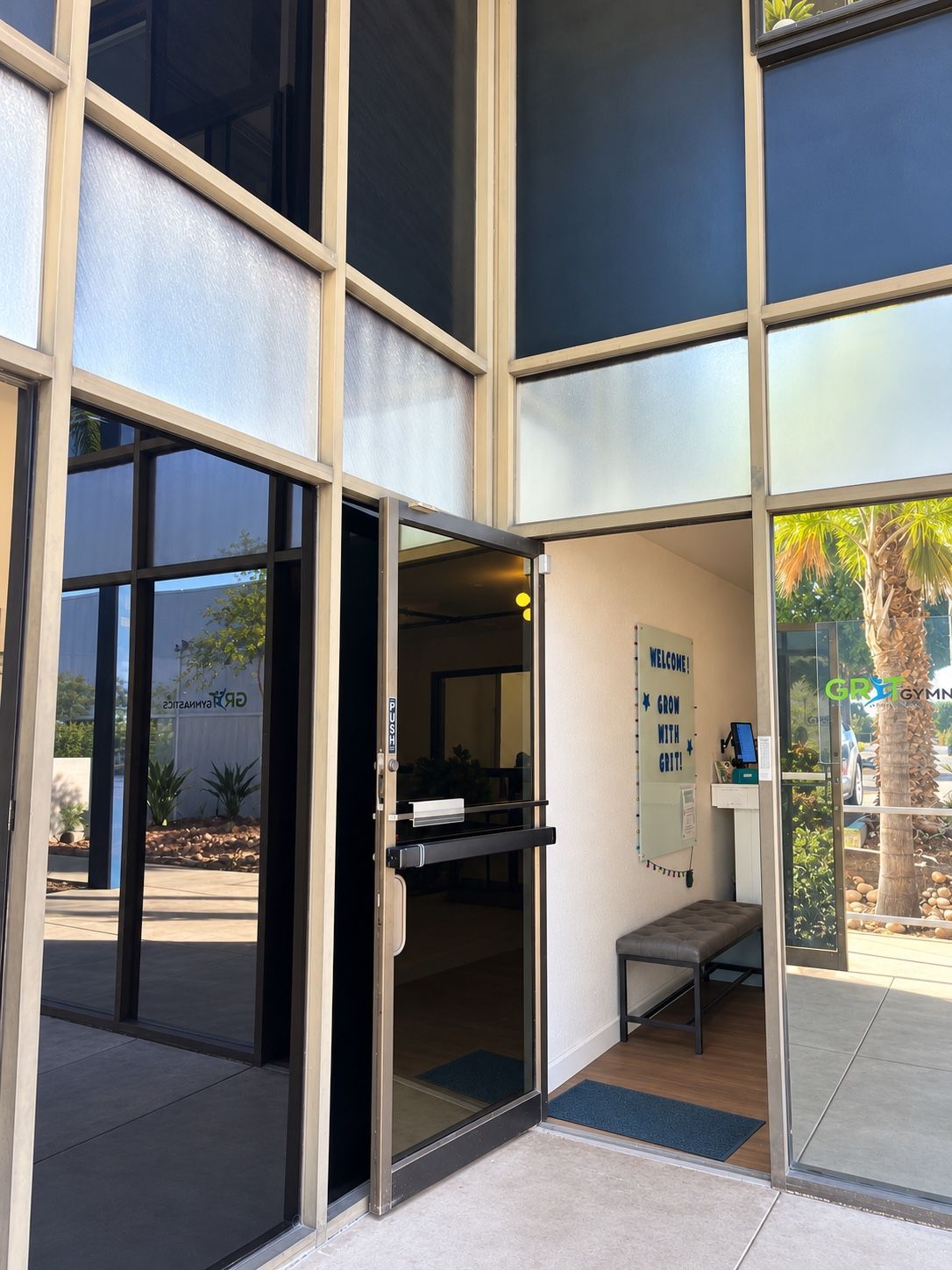Open glass entrance door at GRIT Gymnastics.