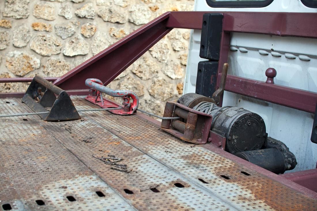 The back of a tow truck with a winch attached to it.