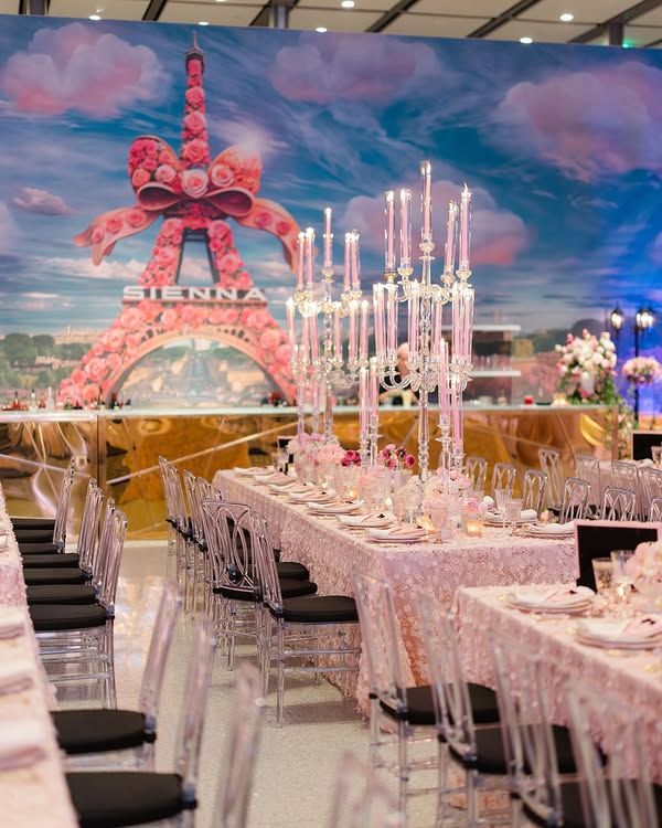 Pink party banquet hall with floral décor, candlelit tables, and a large “SENNA” backdrop