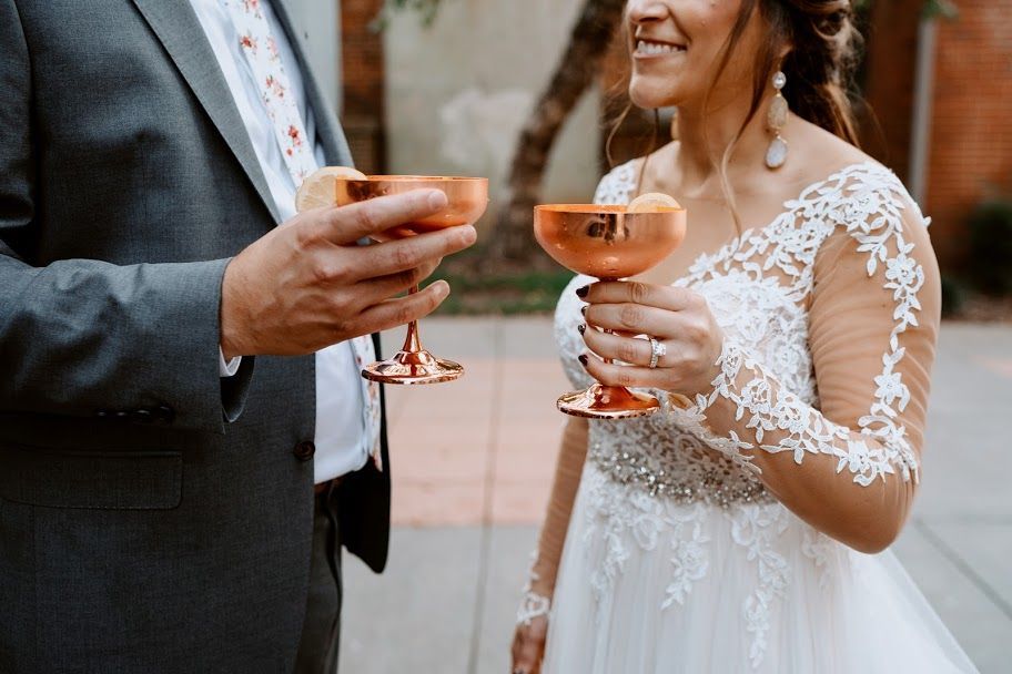 Bride and groom holding champagne glasses at a wedding reception