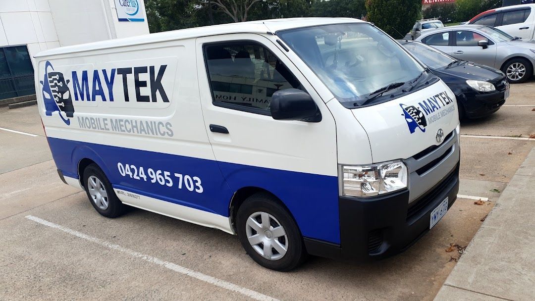 White and blue Maytek mobile maintenance van parked in a lot. Phone number visible.