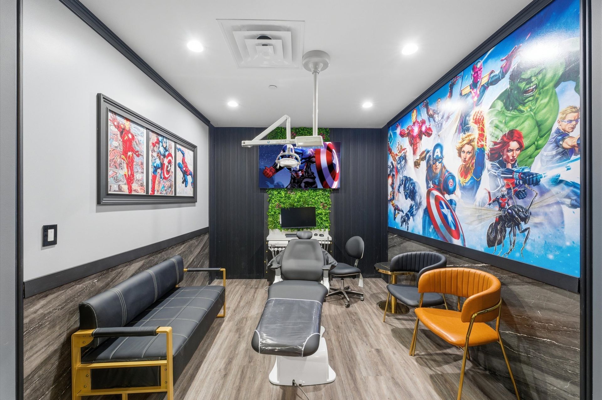 Superhero-themed dental room. Features include a dental chair, framed art, and a large wall mural with Marvel characters. Adventure Smiles Dental and Orthodontics -Pasadena