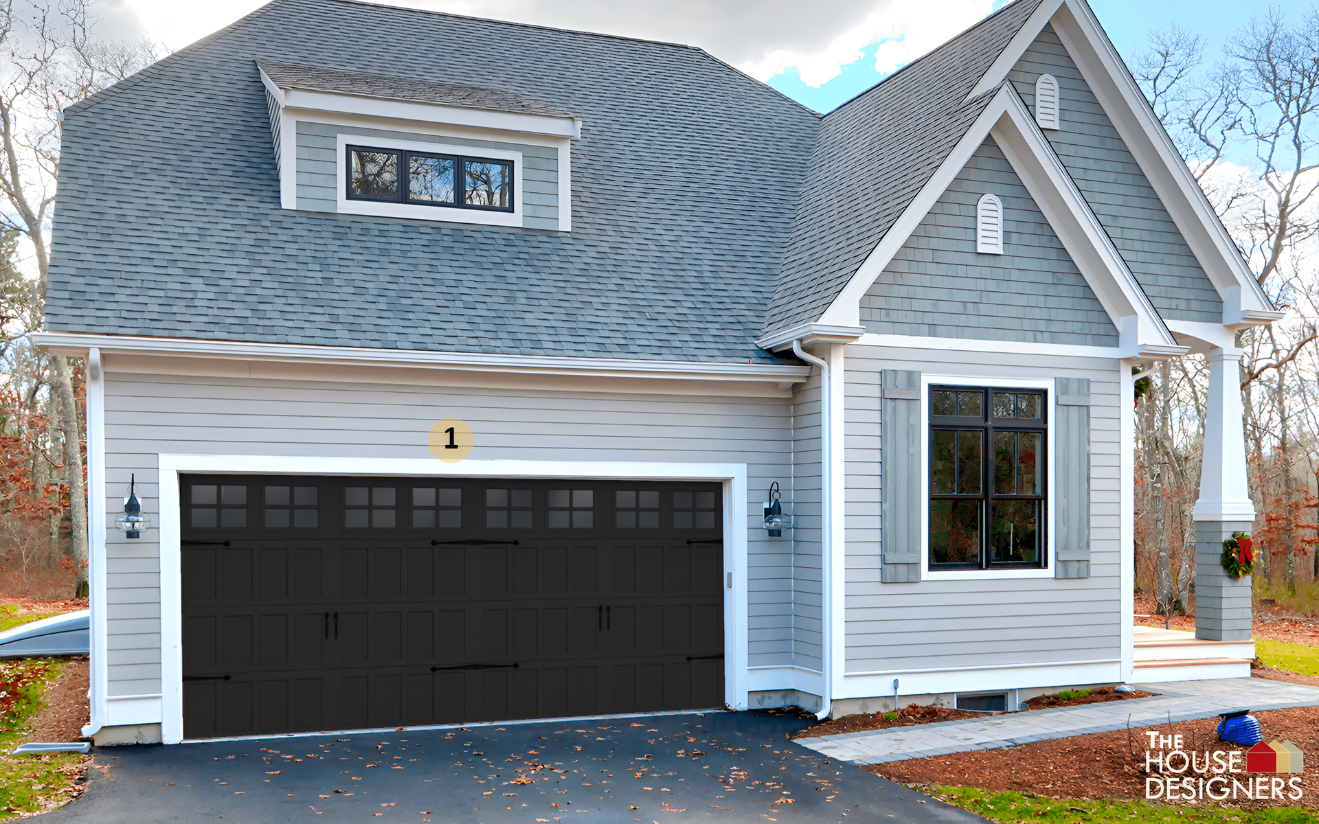 Exterior of a gray house with black garage door and white trim, shown in daylight