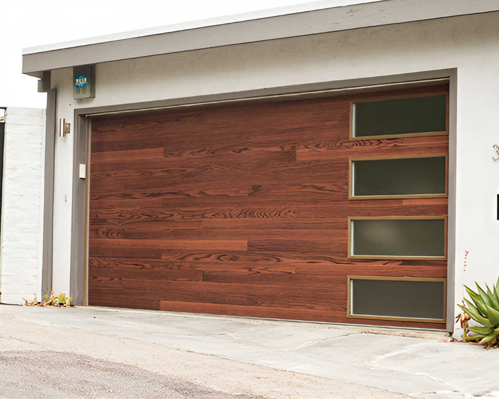Modern house with a large wood-paneled garage door and frosted glass side windows
