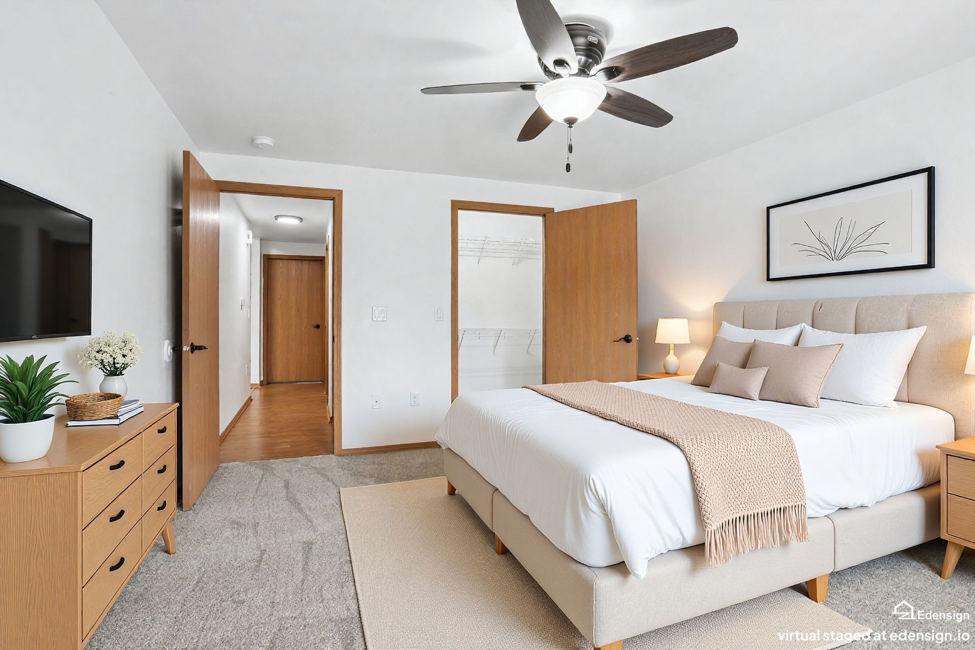 Bright bedroom with a bed, dresser, ceiling fan, and open wooden closet door