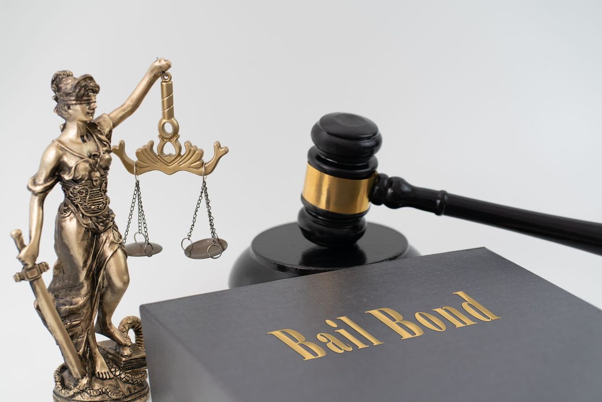 Justice symbols with scales, gavel, and a black “Bail Bond” book.