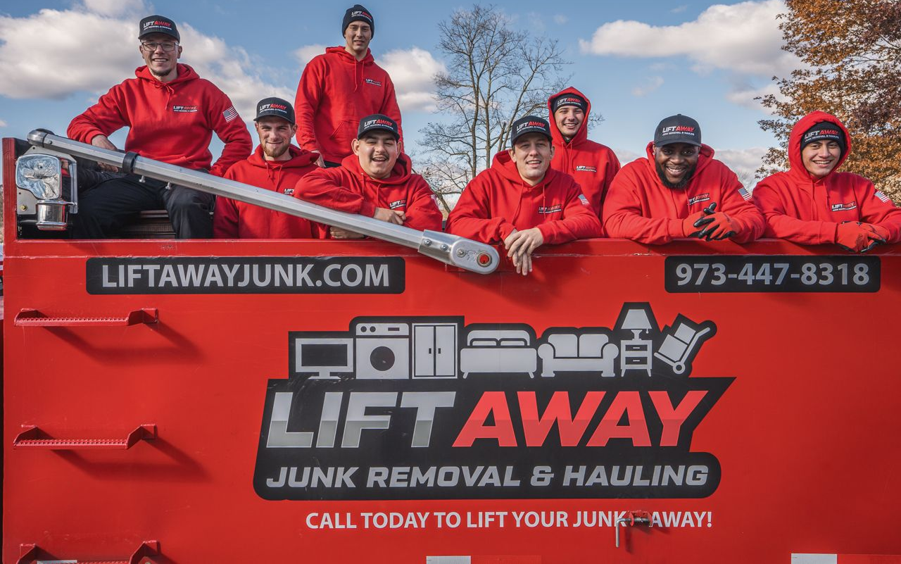 A group of people in red hoodies on a red truck with 