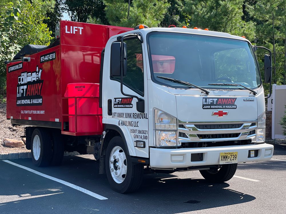 White and red Lift Away truck in a parking lot.