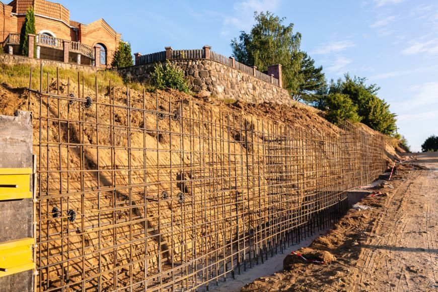 A Fence is Being Built on the Side of a Hill — Ape Earthmoving In Warwick, QLD