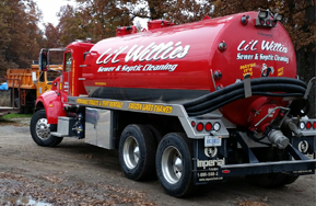 A red truck with lil willies written on the side