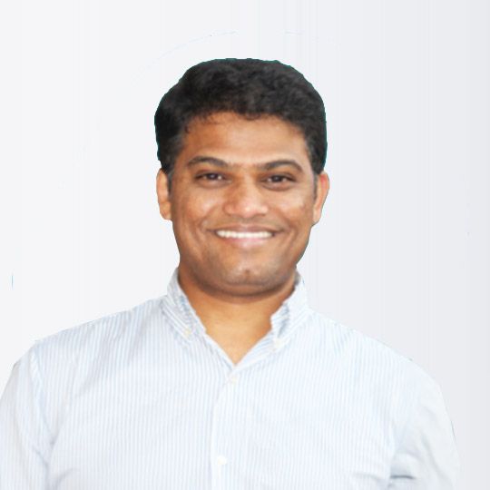 Smiling man in a light blue striped shirt against a plain white background Smiling man in a light blue striped shirt against a plain white background