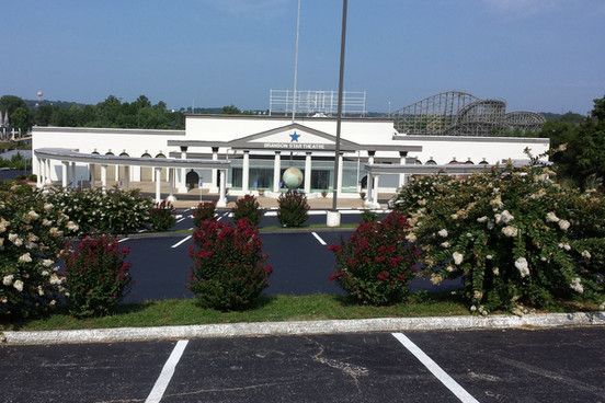A large white building with a flag pole in front of it