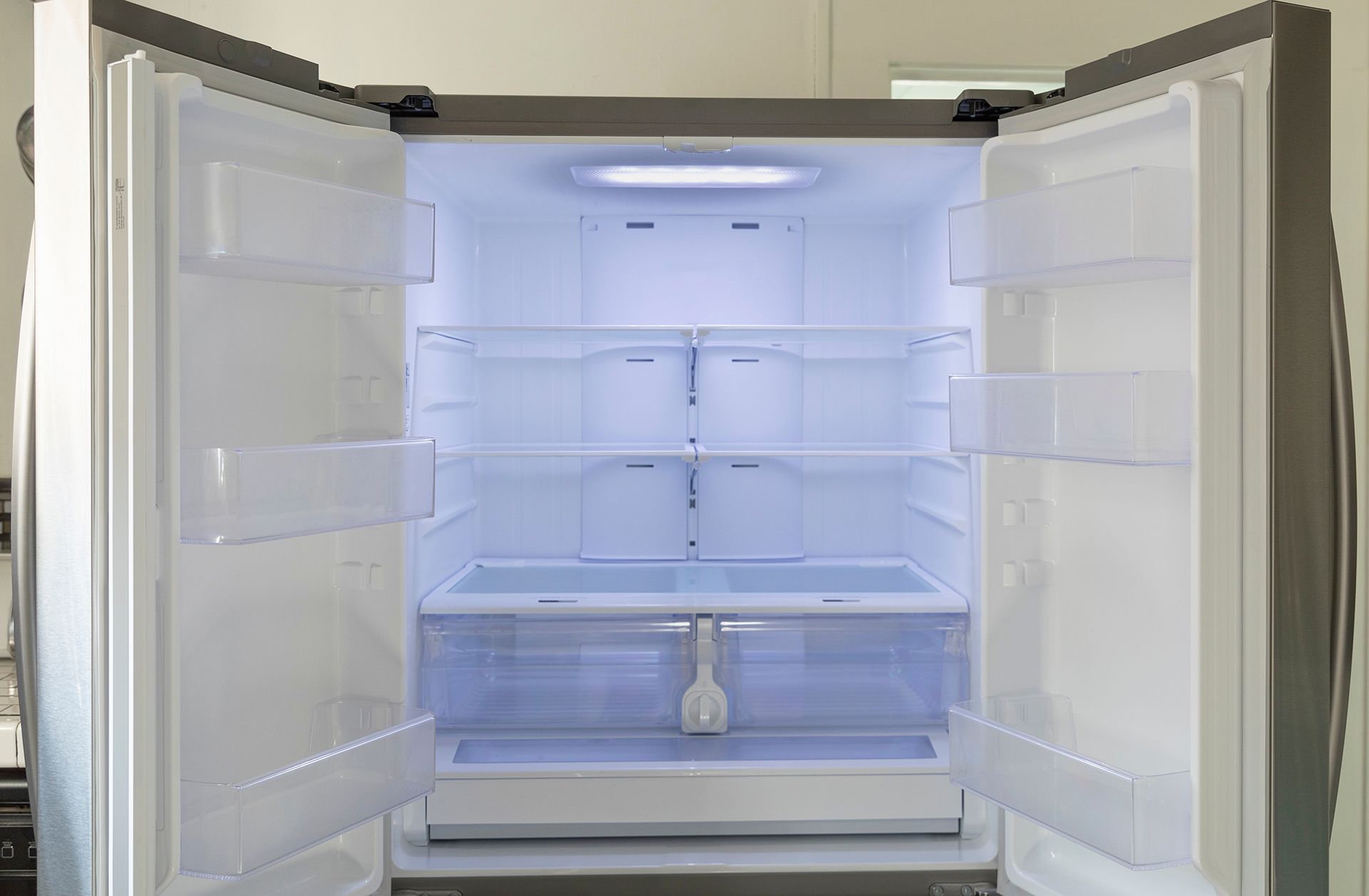 The Inside Of An Empty Refrigerator With The Doors Open — NQ Fridge & Freezer Seals In Manoora, QLD