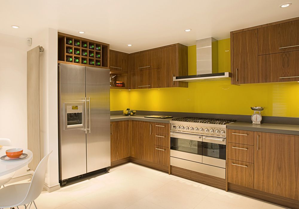 A Kitchen With Stainless Steel Appliances And Wooden Cabinets — NQ Fridge & Freezer Seals In Manoora, QLD