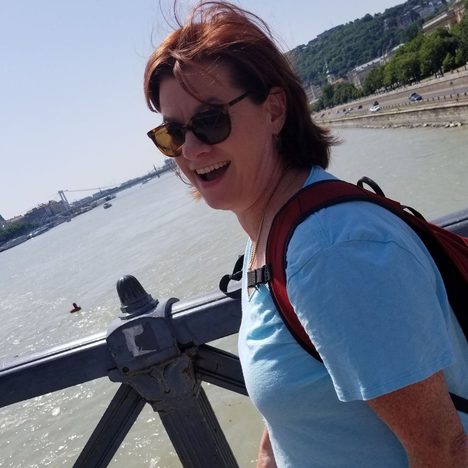 Dianna walking on a bridge over the Danube River in Budapest. Dianna Suggs Travel LLC
404-513-5069