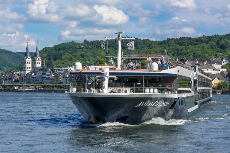 Avalon River cruise boat sailing along the Rhine River with the village of Bacharach in the background