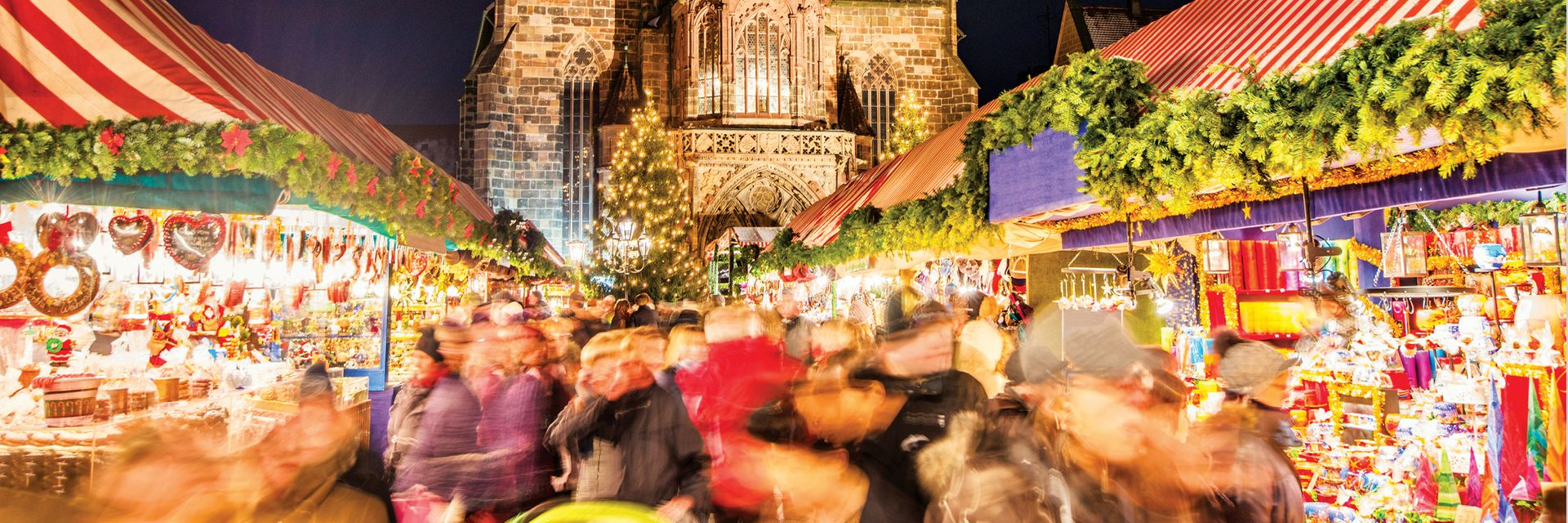 Nuremberg Christmas Market with many lights and Cathedral in the background