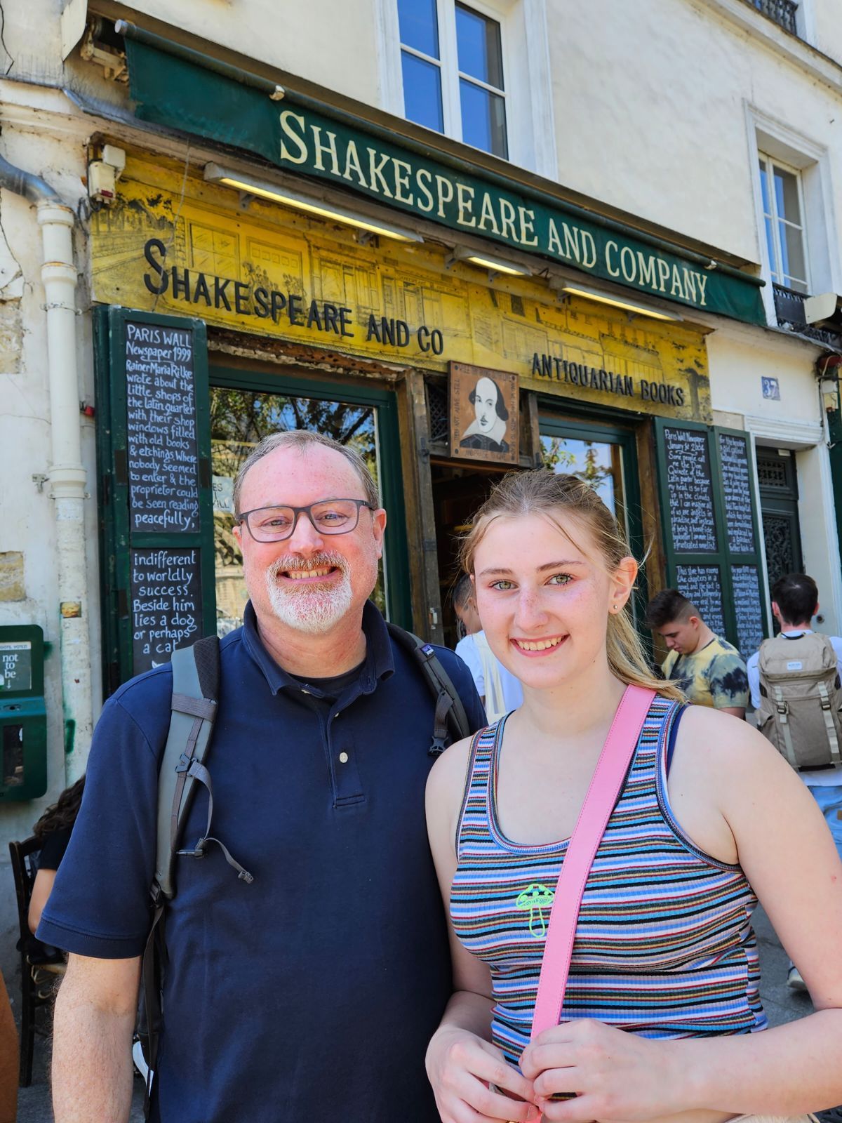 Father and Daughter in front of a Paris book store, Shakespeare and Company.  Travel to Paris with Family call Dianna Suggs Travel LLC 404-513-5069