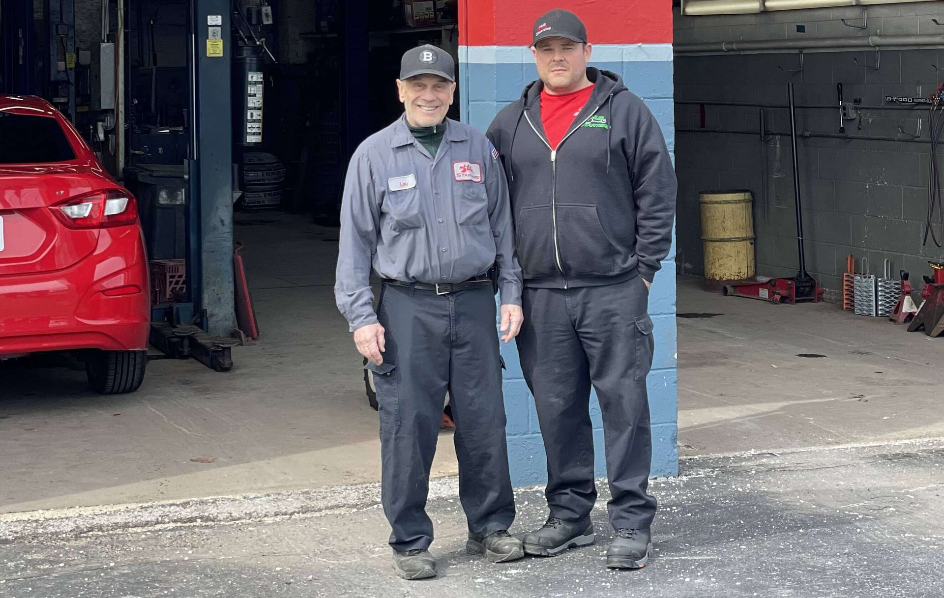 Lou and Brian Farkas standing in front of Hub Starters Auto Repair shop in Malden, Massachusetts