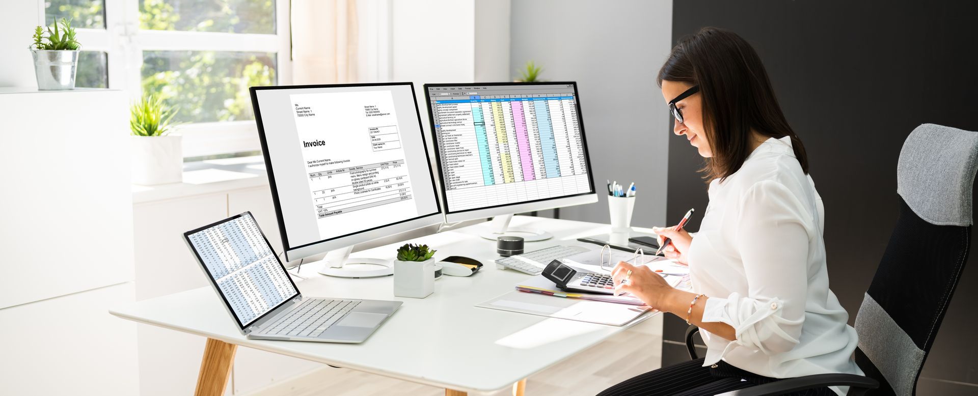 Woman Works at a Desk With Dual Monitors and a Laptop — Careful Books in Torres Strait, QLD