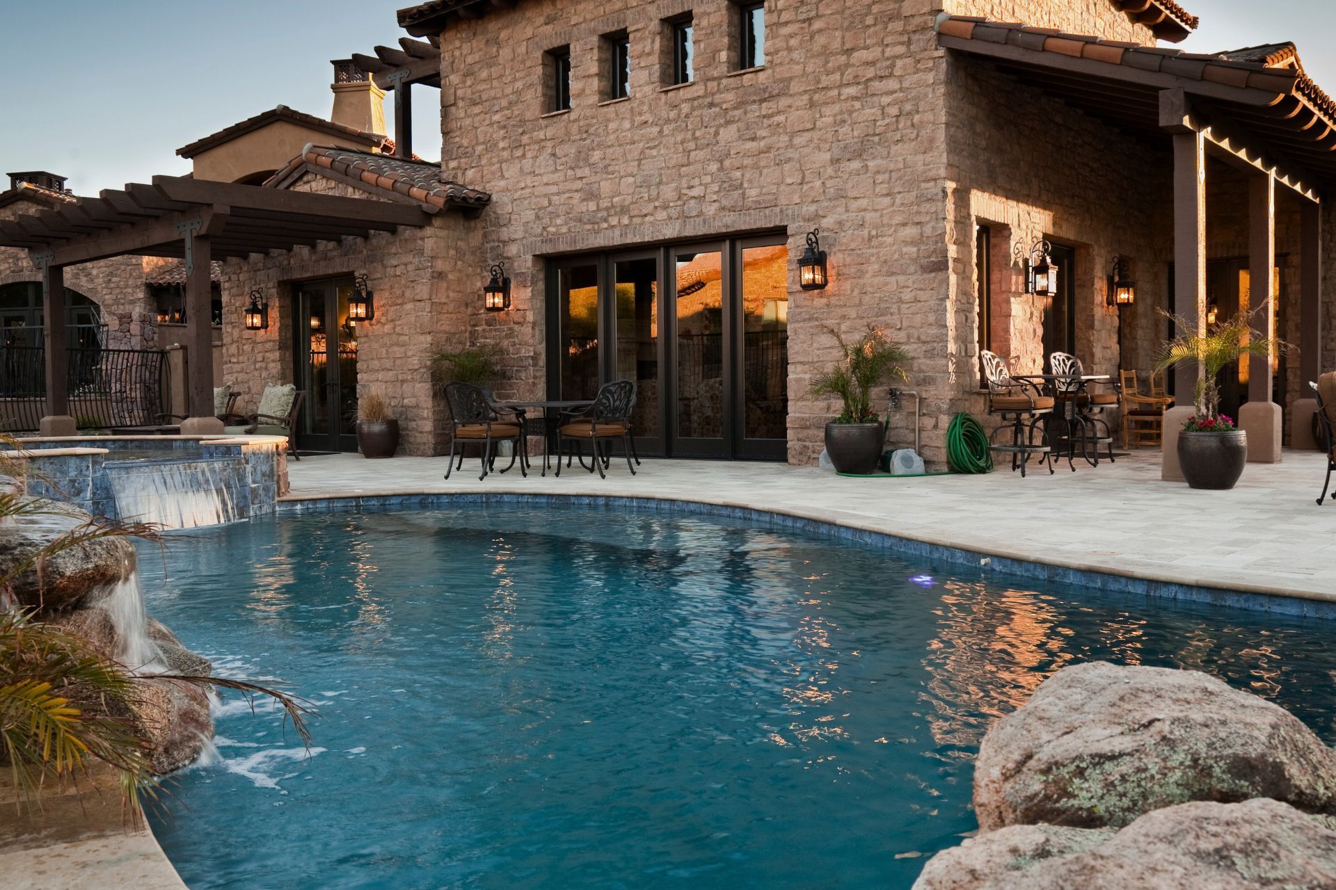 A large house with a large swimming pool in front of it