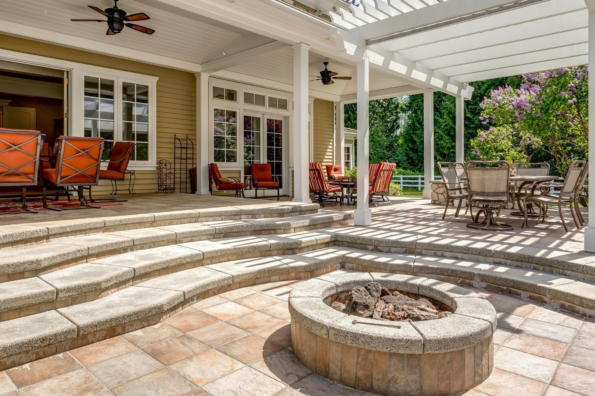 There is a fire pit in the middle of the patio.